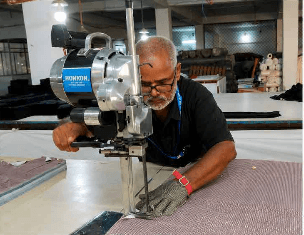 Fabric being spread on cutting table